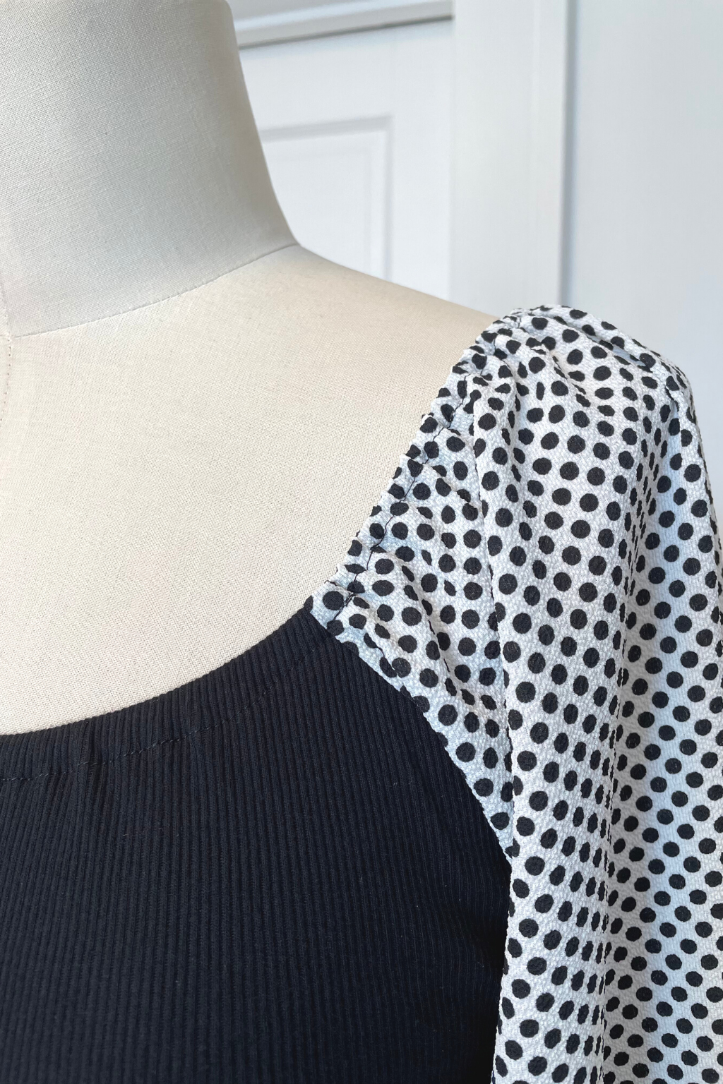 KOKOON Hutton Square Neck Dress in Black Rib Knit With White and Black Polka Dot Sleeves Front Detail